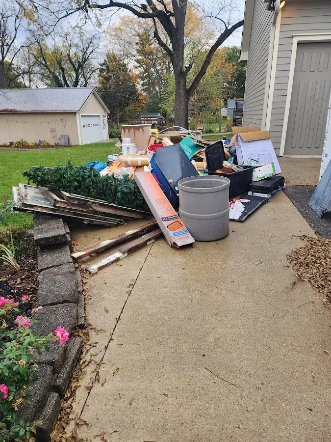 Dumpster being loaded with debris for Commercial Dumpster Rental in Oskaloosa